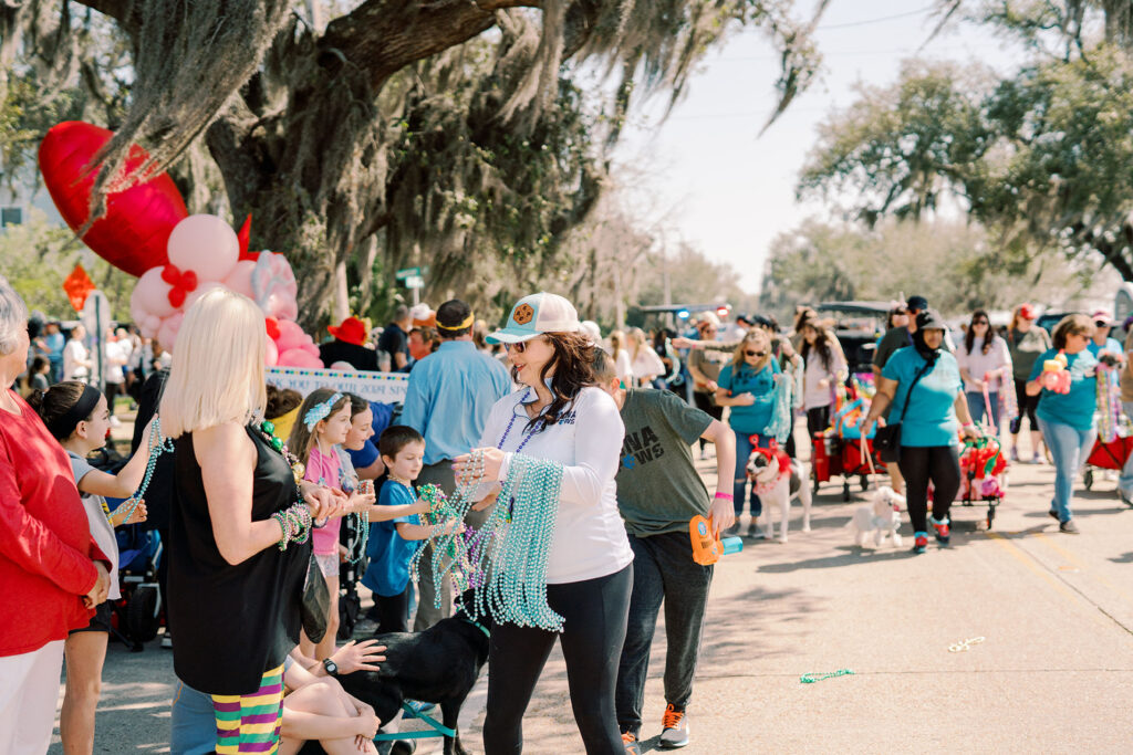 photo of a woman handing out beads