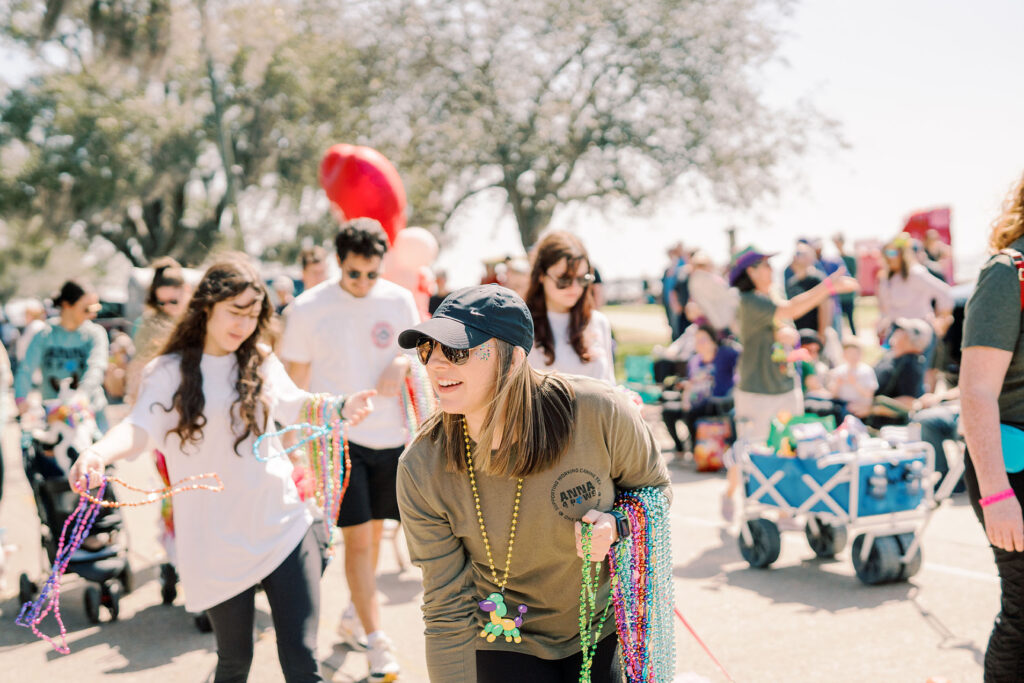 photo of someone handing out beads