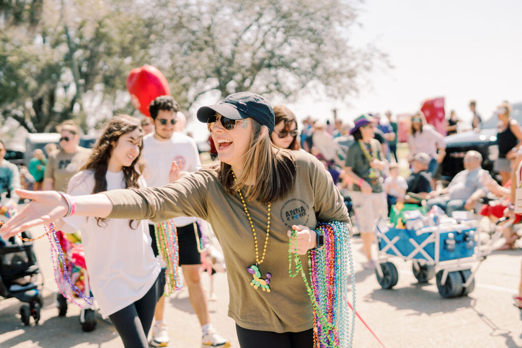 photo of someone handing out beads